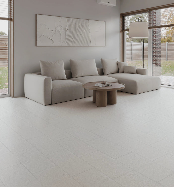 COREtec CRT02 Balanced Retreat Silver Mist Concrete waterproof luxury vinyl tile installed in a room setting