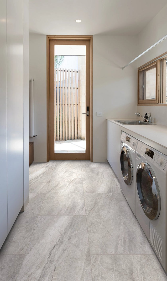 COREtec Natural Opula Graphite Travertine installed in dramatic contemporary kitchen with dark stone aesthetic